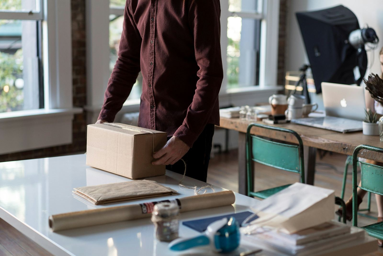 An online store owner packing a parcel for an order